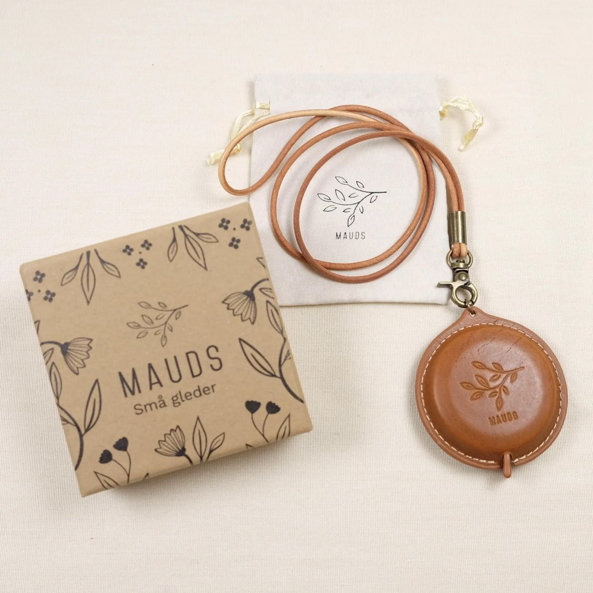 Rullemålbånd i eksklusivt skinn med avtagbar snor